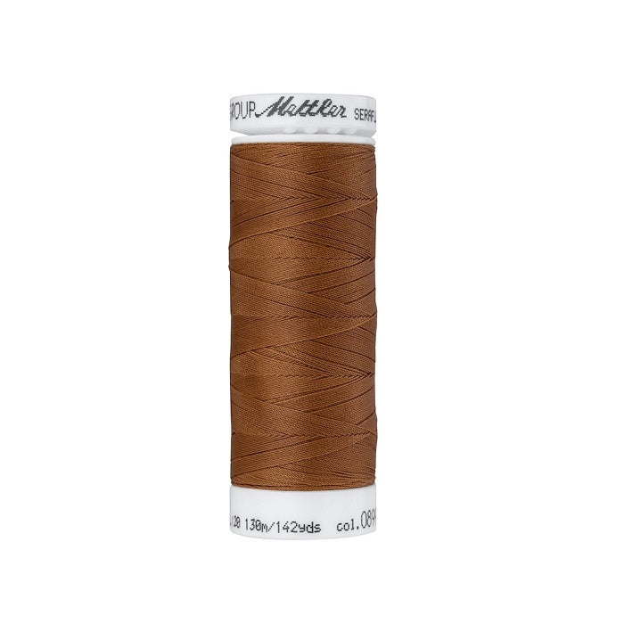 Spool of brown thread with Mettler Seraflex branding.