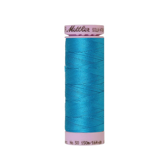 Blue thread with Mettler Cotton 50 branding.