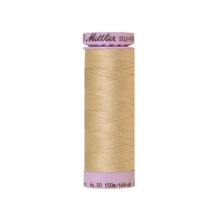 Beige thread with Mettler Cotton 50 branding.