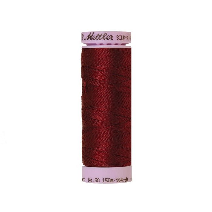 Dark red thread with Mettler Cotton 50 branding.
