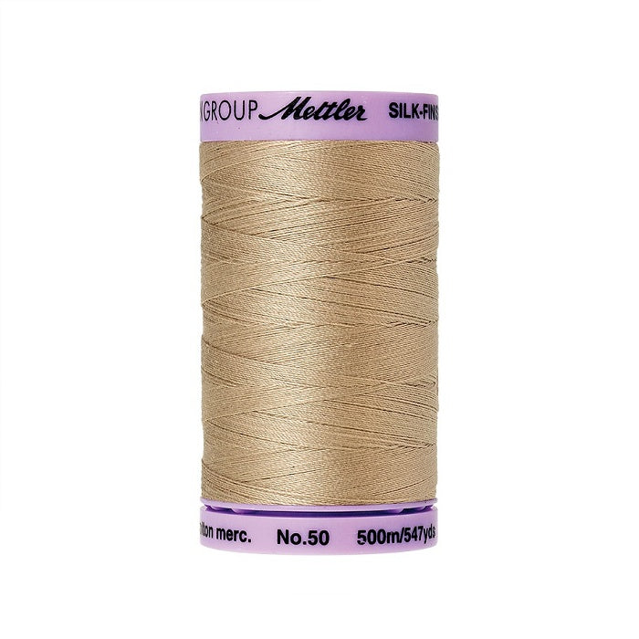 Beige thread with Mettler Cotton 50 branding.