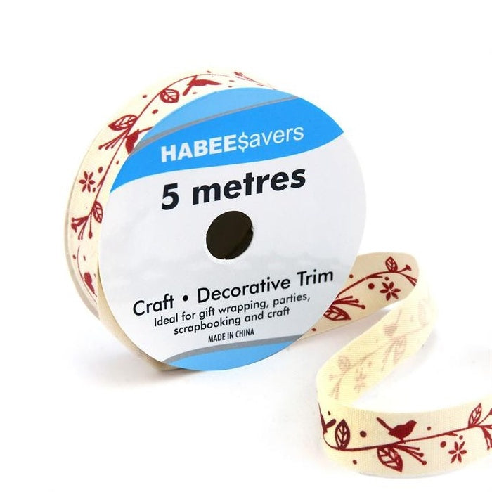 Roll of cream ribbon with red birds on a leafy garland.