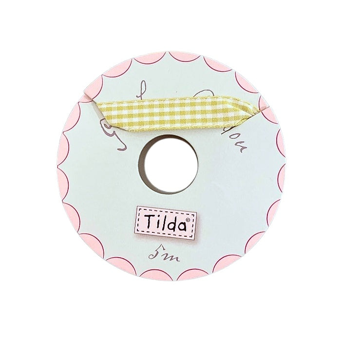 Green checked ribbon on a spool with Tilda branding.