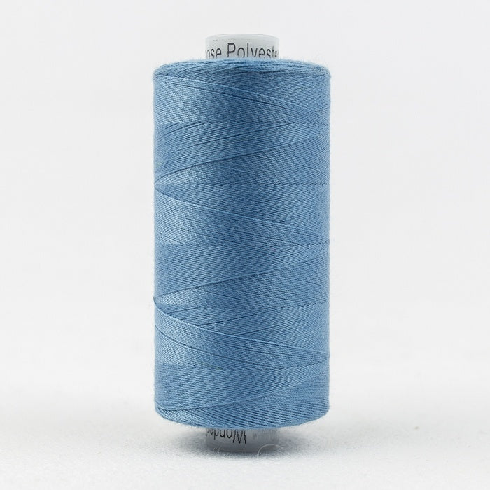 Spool of light blue thread with Designer branding.