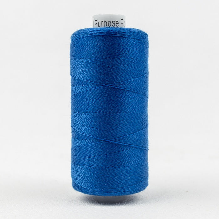 Spool of cobalt blue thread with Designer branding.