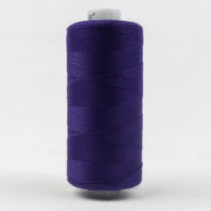 Spool of indigo blue thread with Designer branding.