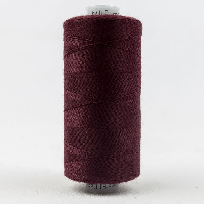Spool of burgundy thread with Designer branding.