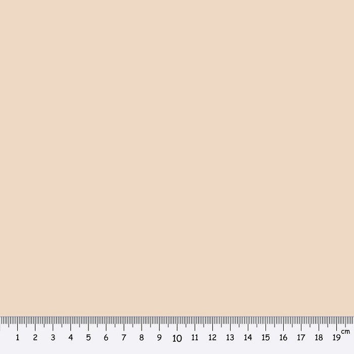 Beige fabric swatch with a ruler at the bottom for scale.