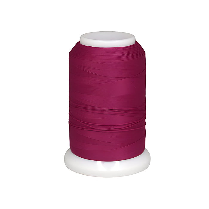 Spool of dark pink woolly nylon thread.