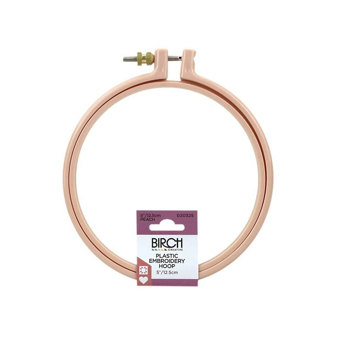 Round, peach coloured plastic embroidery hoop with birch branding.