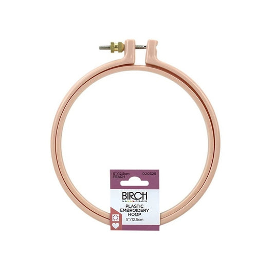 Round, peach coloured plastic embroidery hoop with birch branding.