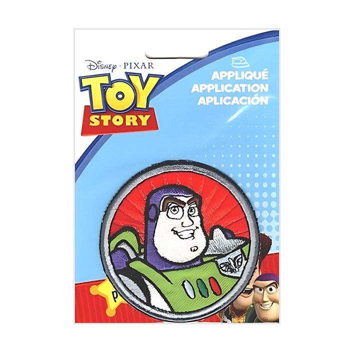 Round applique with smiling spaceman face.