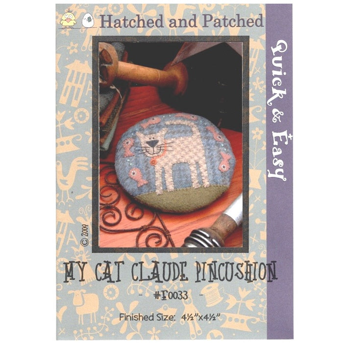 Pattern cover of pincushion with smiling cat and goldfish applique.