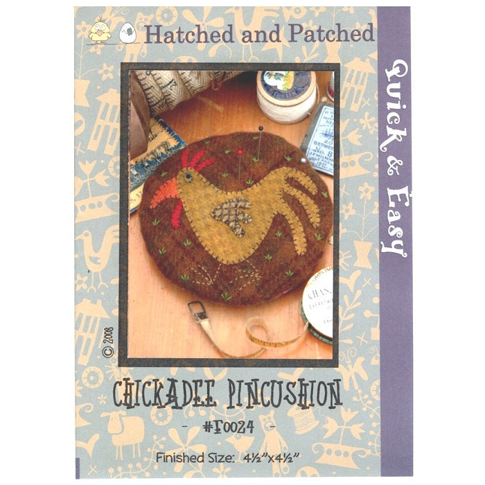 Pattern cover of pincushion with  appliqued chicken.