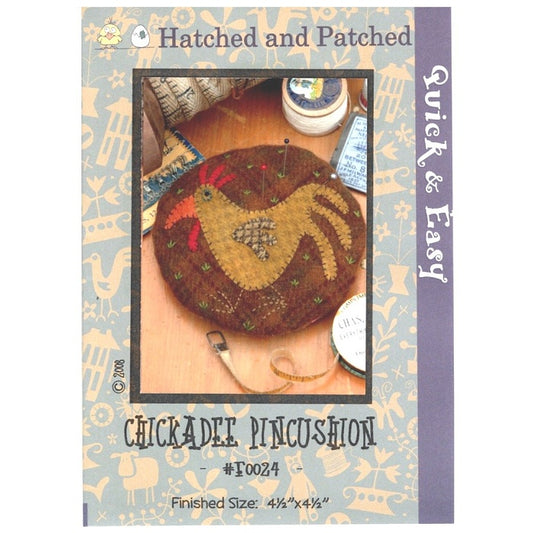 Pattern cover of pincushion with  appliqued chicken.