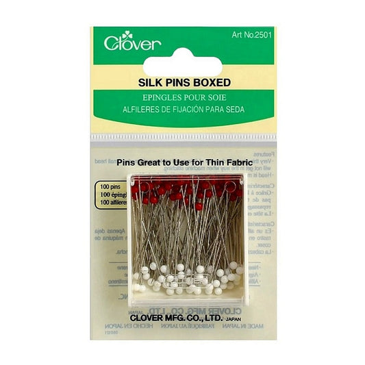 Red and white pins in a bclear box with Clover branding.