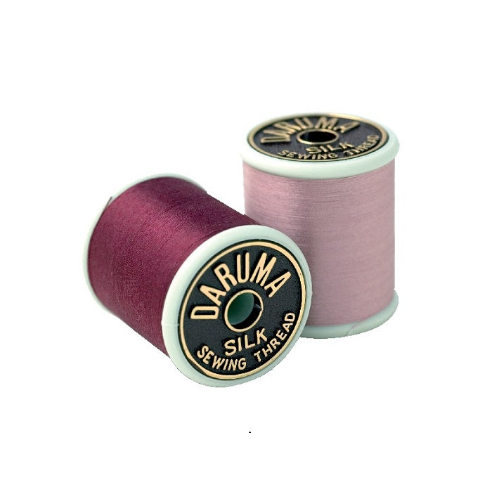 Two spools of silk sewing thread with Daruma branding.