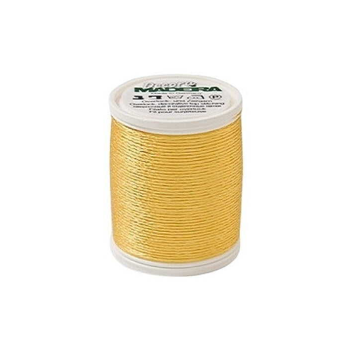 Spool of yellow thread with Madeira branding.