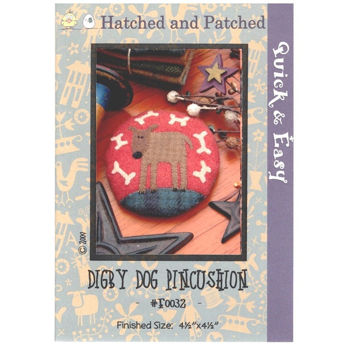 Pattern cover of pincushion with appliqued dog and bones.