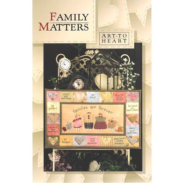 Sewing pattern cover of a wall art stitchery with families are forever theme.
