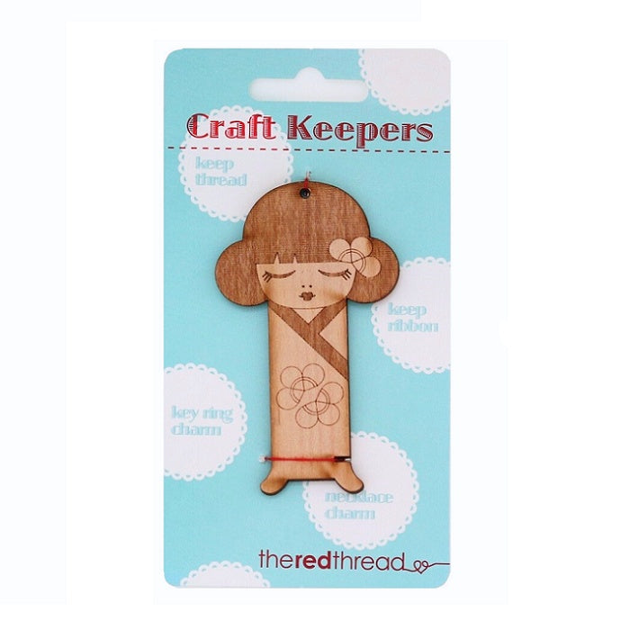 Wooden girl in kimono shaped floss keeper.