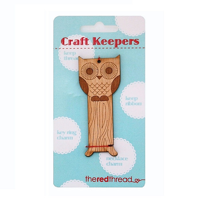 Wooden owl shaped floss keeper.