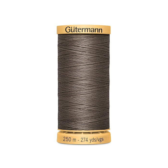 Spool of brown cotton thread with Gutermann branding.