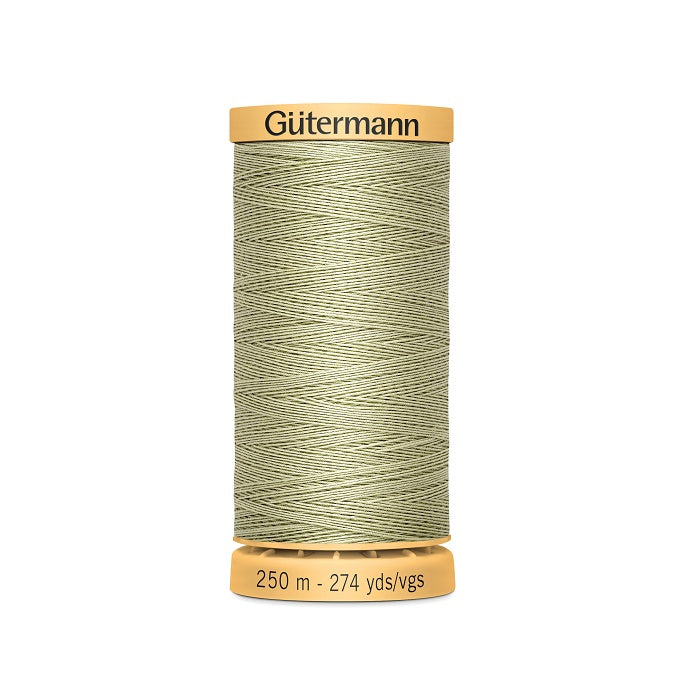 Spool of light khaki green cotton thread with Gutermann branding.