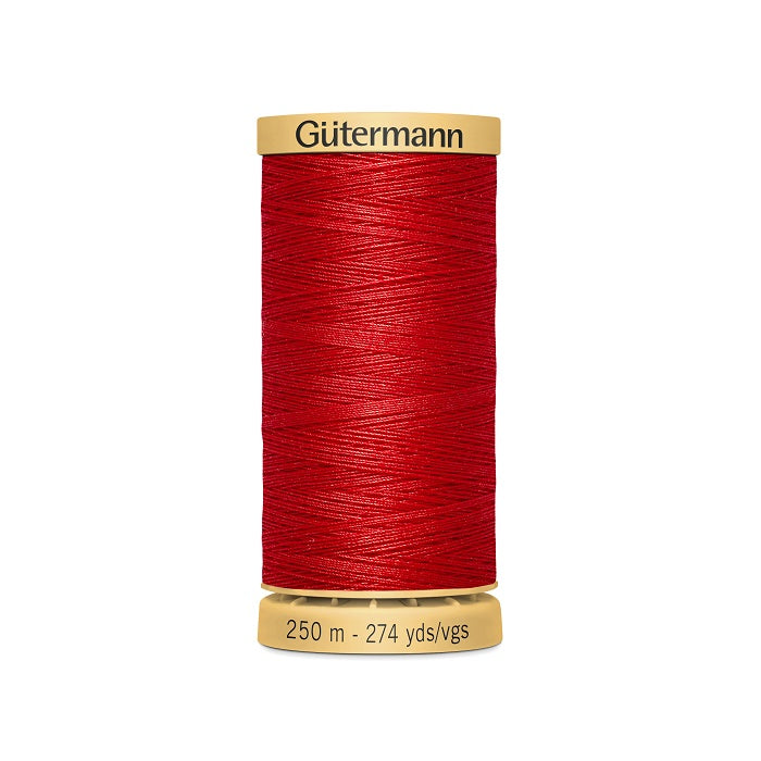 Spool of red cotton thread with Gutermann branding.