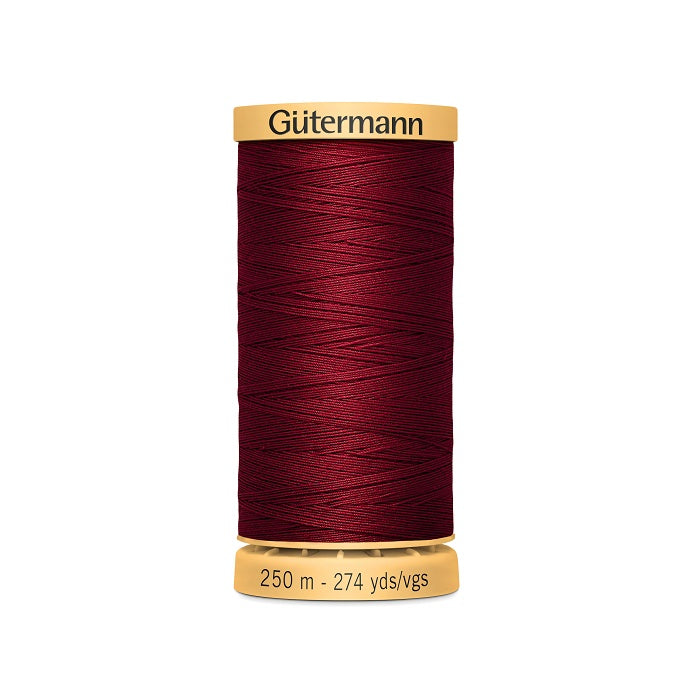 Spool of dark red cotton thread with Gutermann branding.