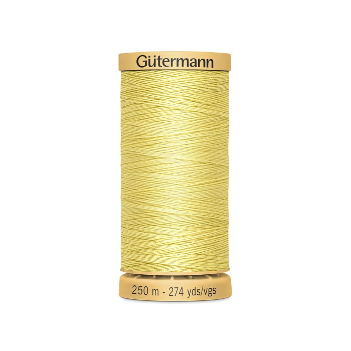 Spool of yellow cotton thread with Gutermann branding.