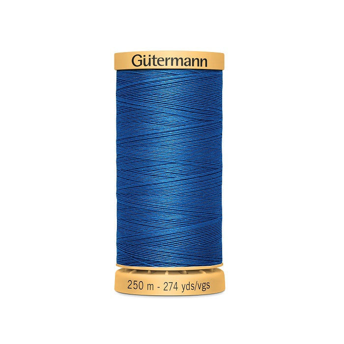 Spool of blue cotton thread with Gutermann branding.