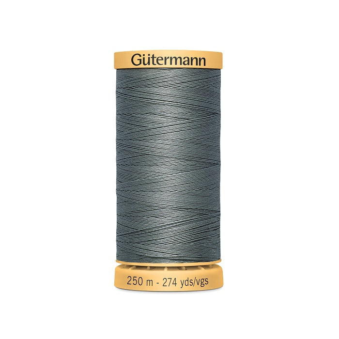 Spool of grey cotton thread with Gutermann branding.