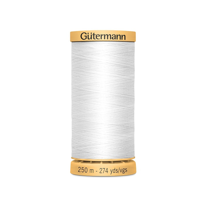 Spool of white cotton thread with Gutermann branding.