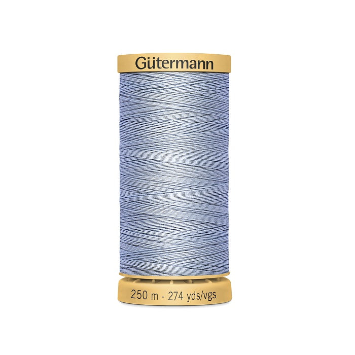 Spool of light dusty blue cotton thread with Gutermann branding.