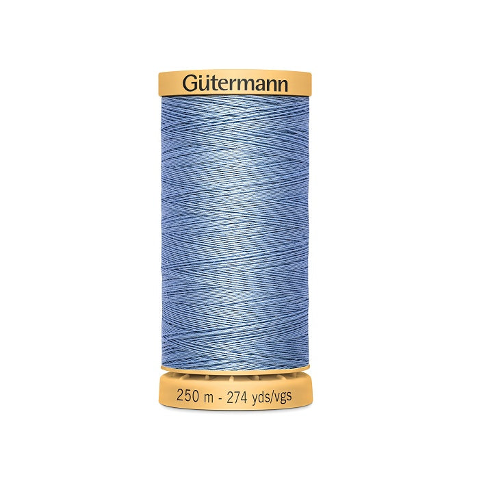 Spool of blue cotton thread with Gutermann branding.