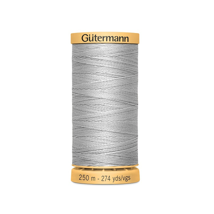 Spool of grey cotton thread with Gutermann branding.