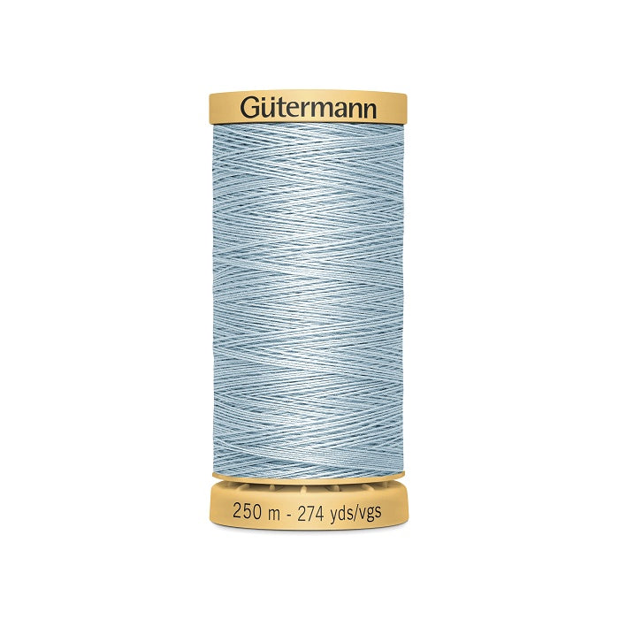 Spool of light blue cotton thread with Gutermann branding.