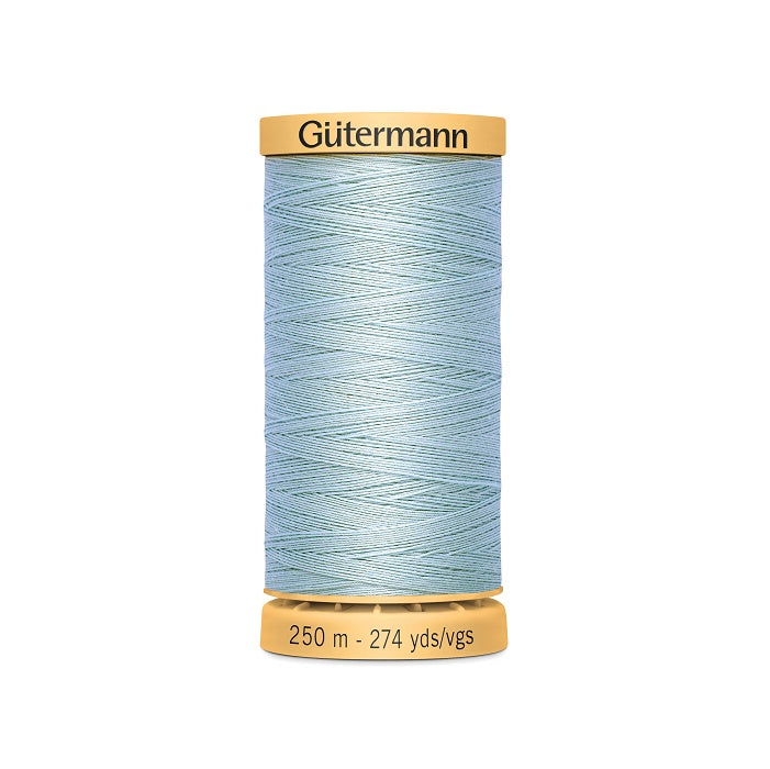 Spool of light blue cotton thread with Gutermann branding.