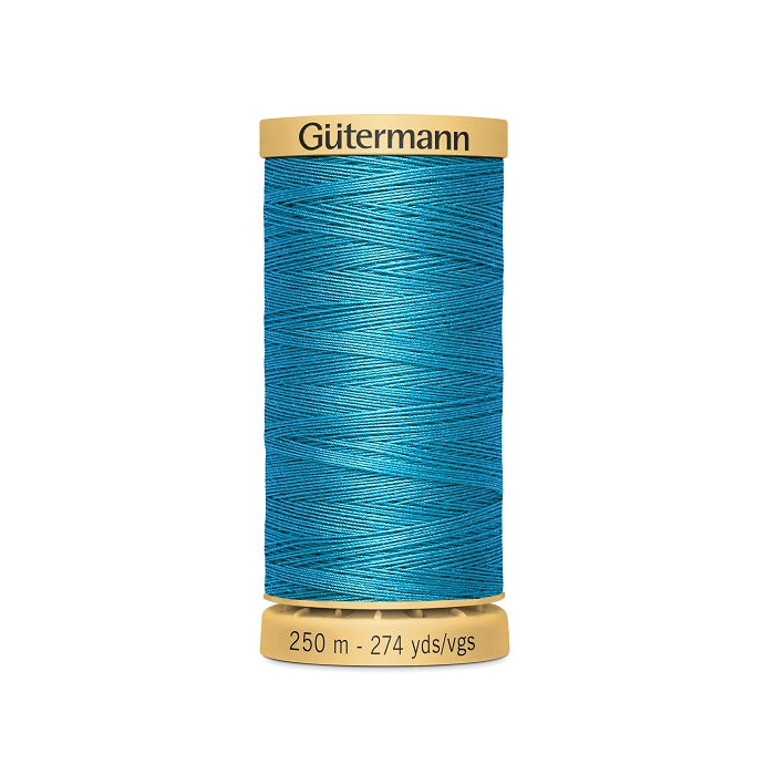 Spool of blue cotton thread with Gutermann branding.