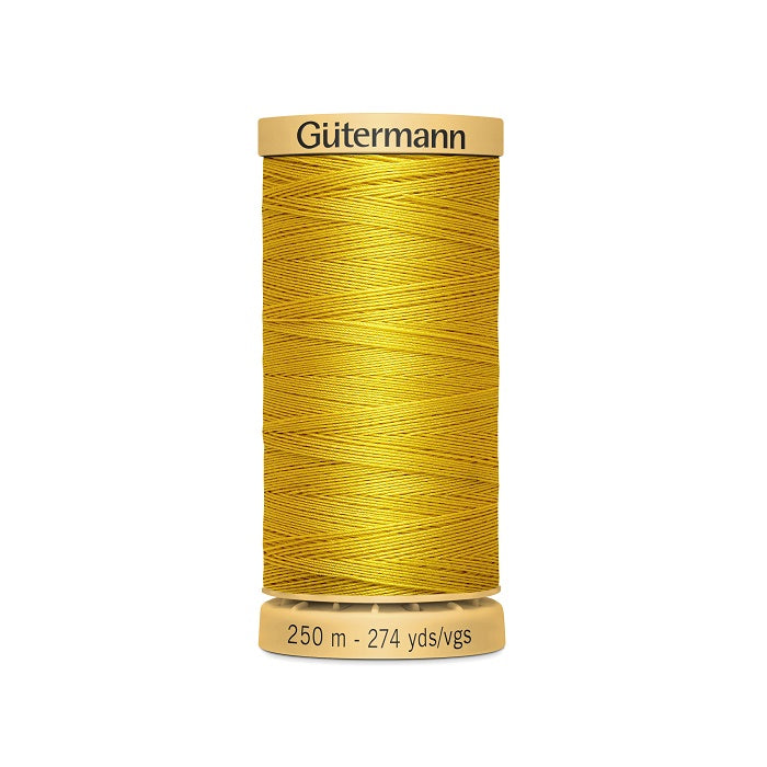 Spool of yellow cotton thread with Gutermann branding.