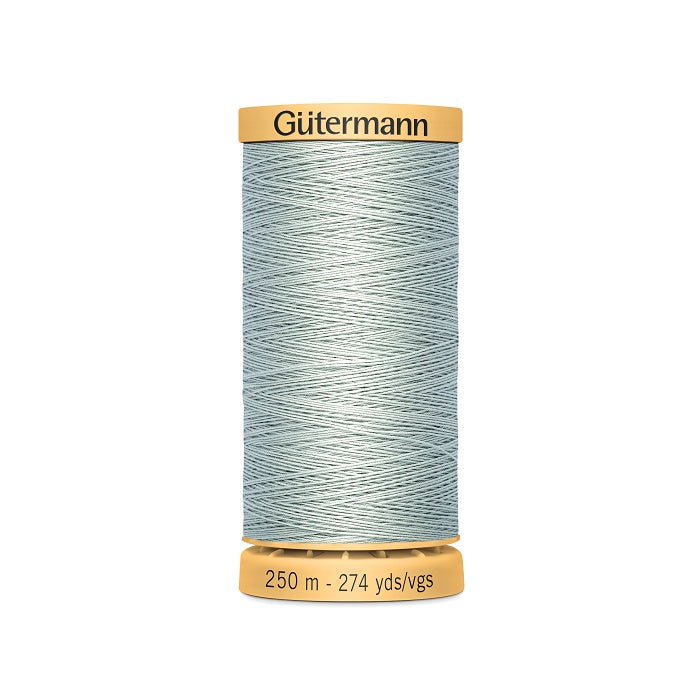 Spool of light pale blue cotton thread with Gutermann branding.
