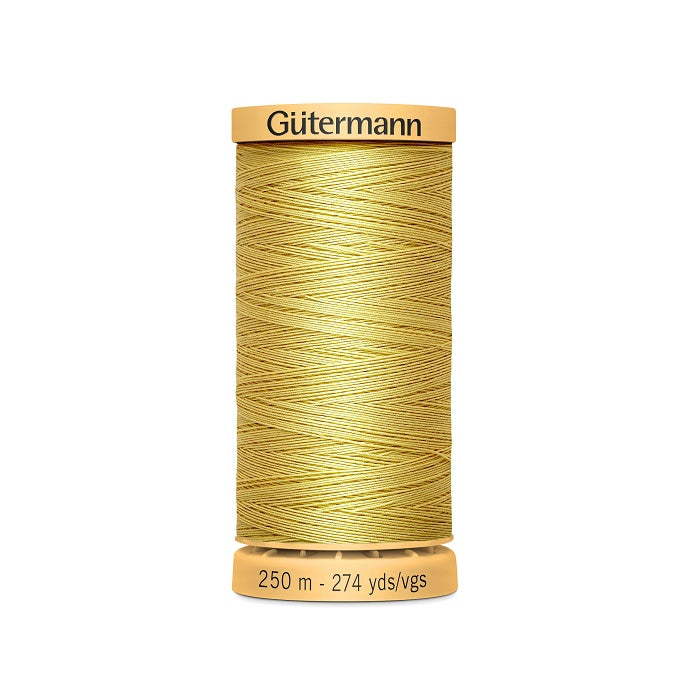 Spool of yellow cotton thread with Gutermann branding.