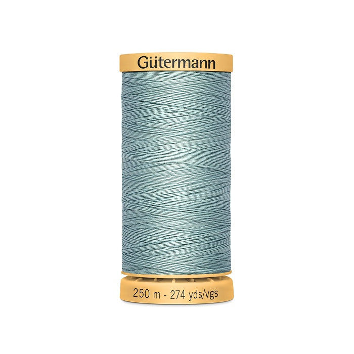 Spool of pale blue cotton thread with Gutermann branding.