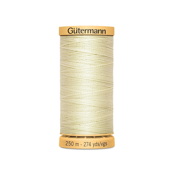 Spool of beige cotton thread with Gutermann branding.