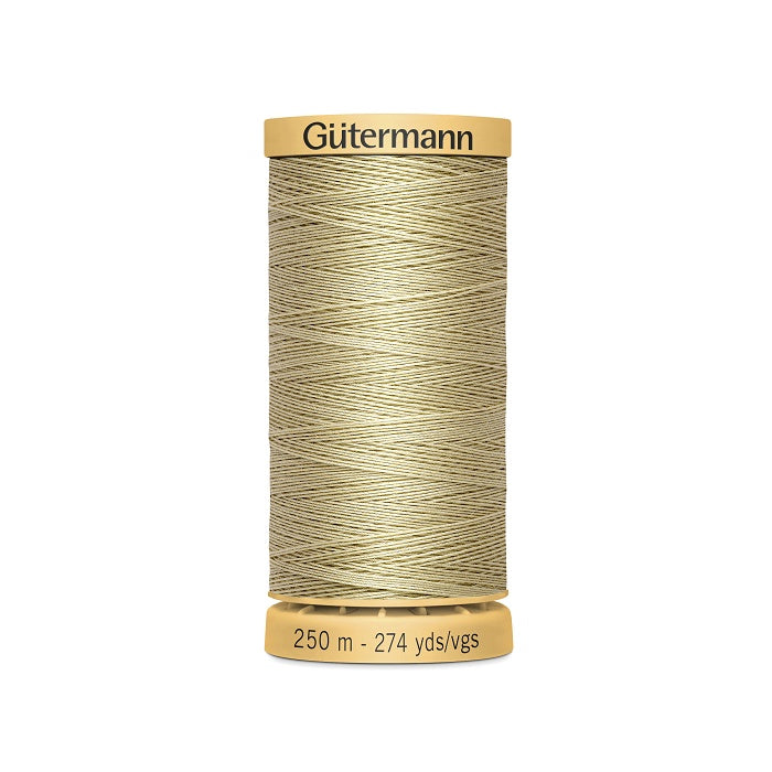 Spool of beige cotton thread with Gutermann branding.