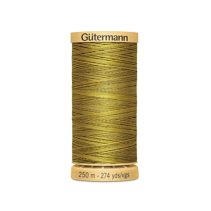 Spool of yellow gold cotton thread with Gutermann branding.