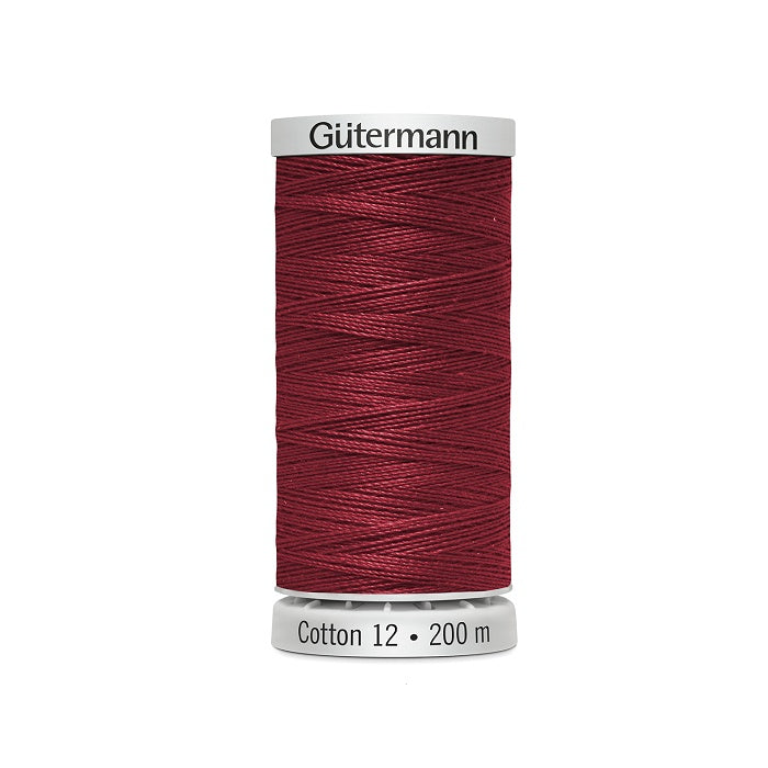 Spool of dark red thread with Gutermann Cotton 12 branding.
