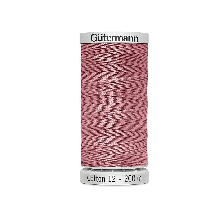 Spool of slamon pink thread with Gutermann Cotton 12 branding.