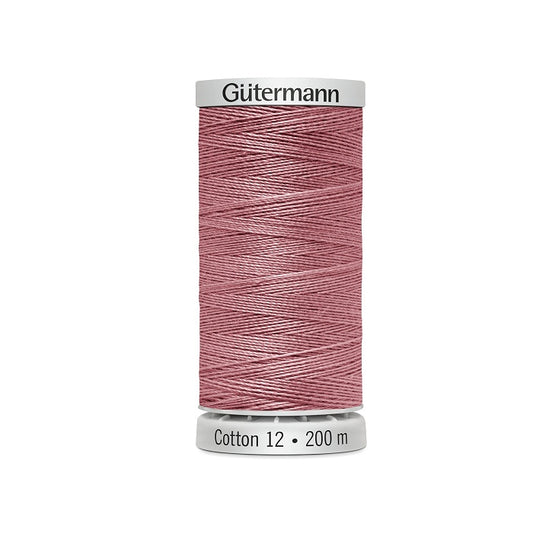 Spool of slamon pink thread with Gutermann Cotton 12 branding.